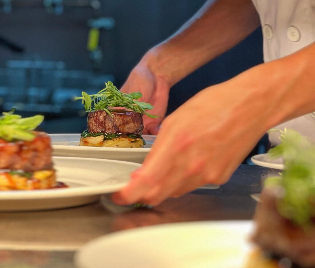 Chef presenting freshly prepared Welsh dish at The Welsh House restaurant